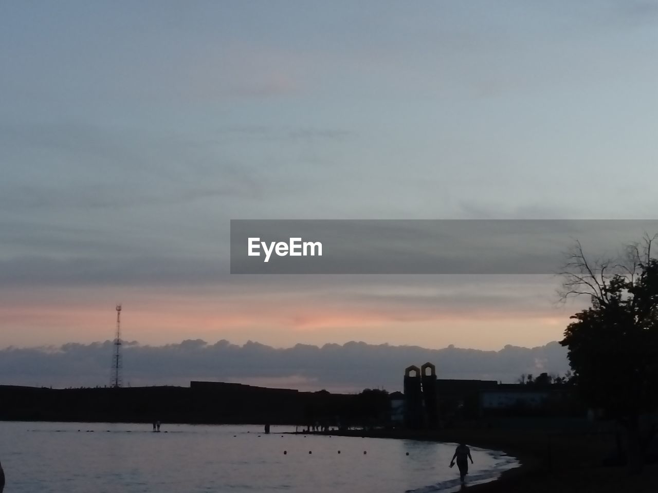 Scenic view of river against sky at sunset