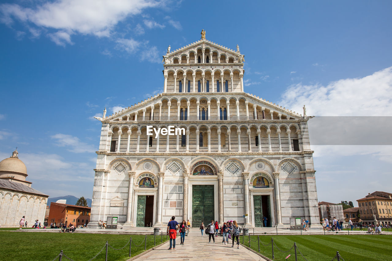 Tourists at the primatial metropolitan cathedral of the assumption of mary in pisa