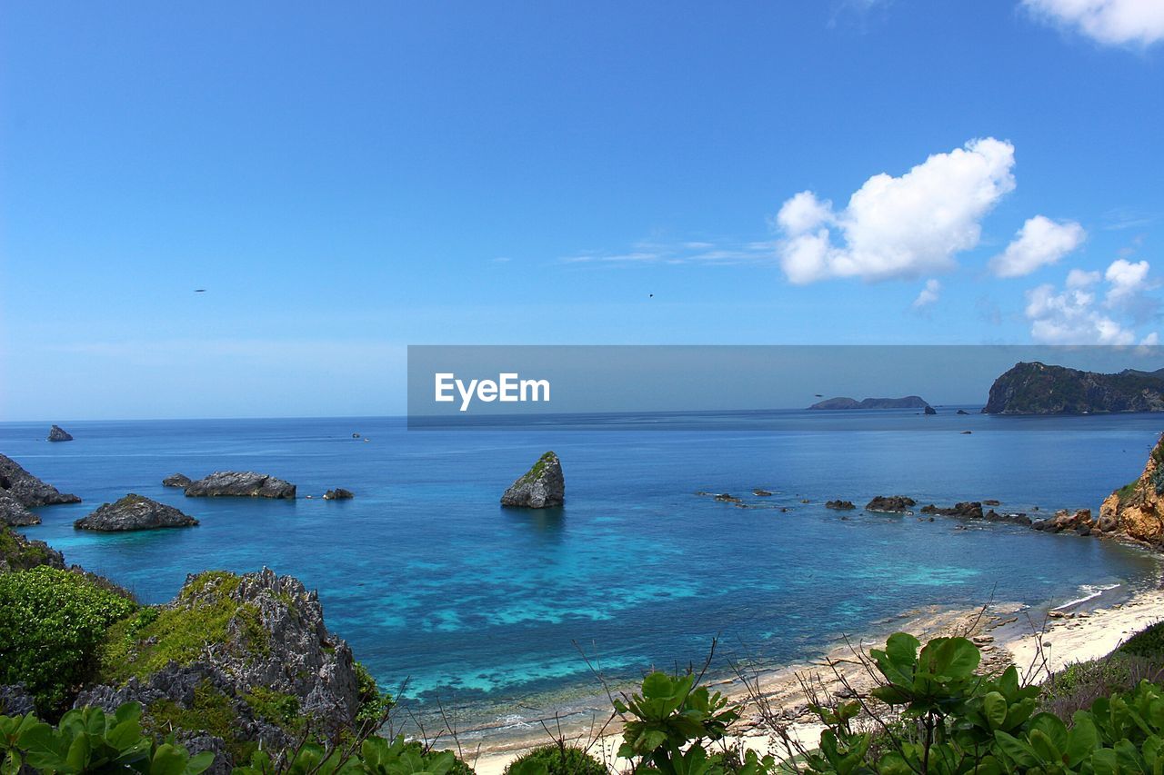 Scenic view of sea against blue sky