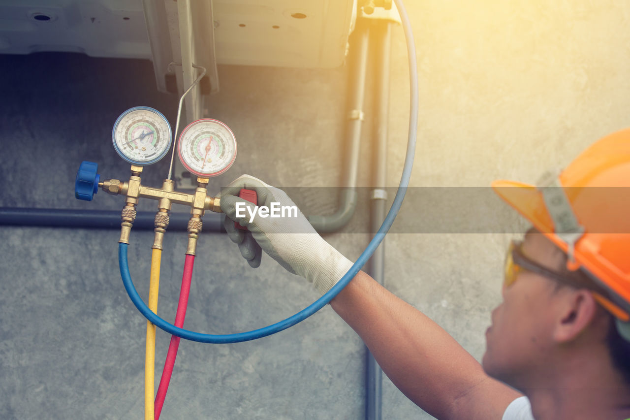 Worker looking at pressure gauge