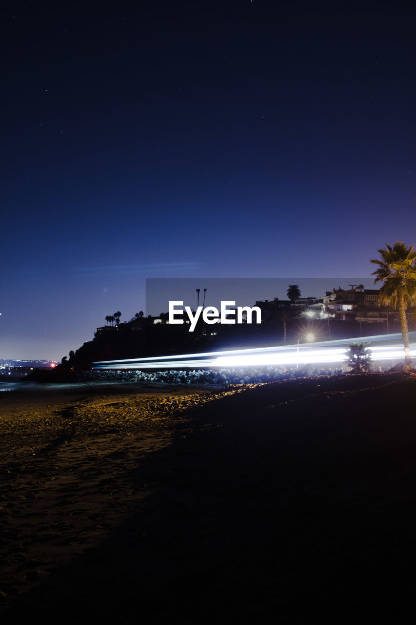 VIEW OF BEACH AGAINST SKY AT NIGHT