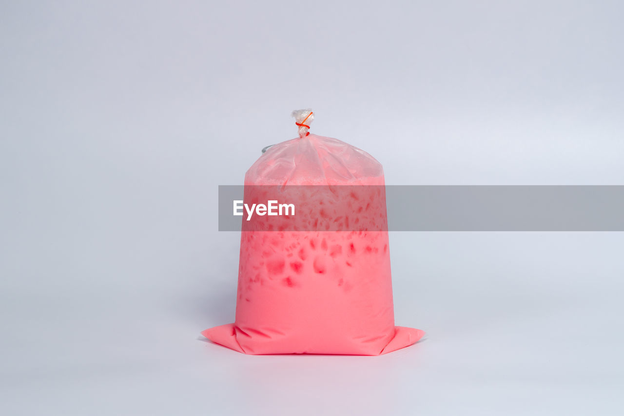 pink, studio shot, lighting, single object, candle, indoors, red, no people, copy space, food and drink, white background, food