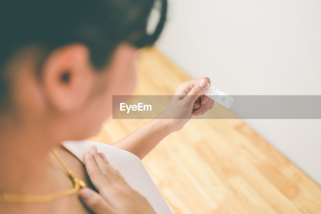 Close-up of woman holding pregnancy test