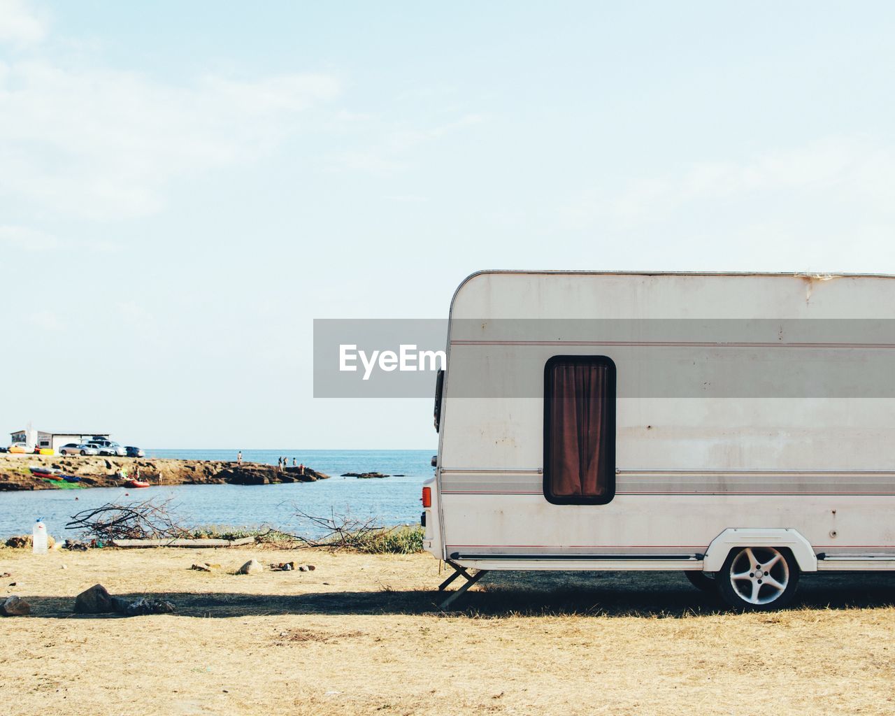 Van on beach against sky