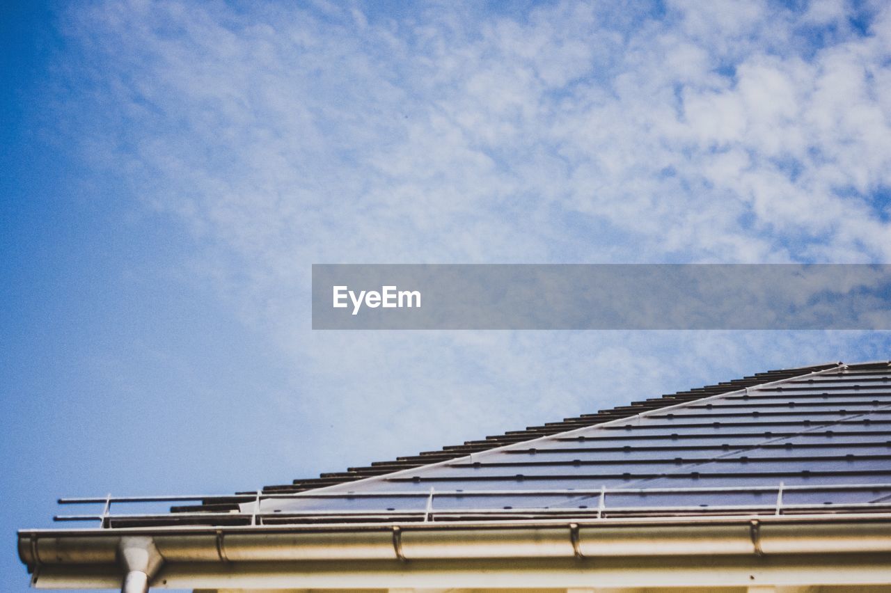 Low angle view of building roof against sky