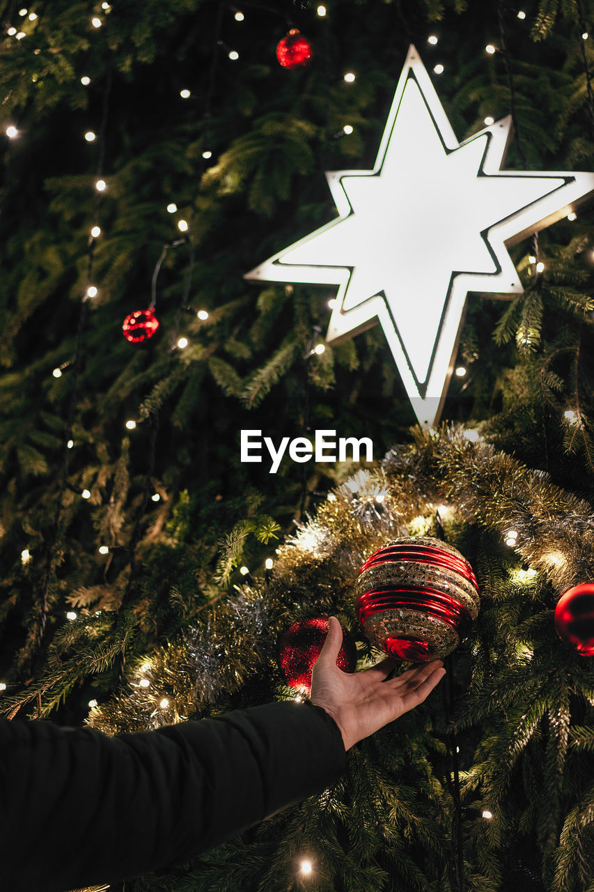 Close-up of person holding christmas decoration 