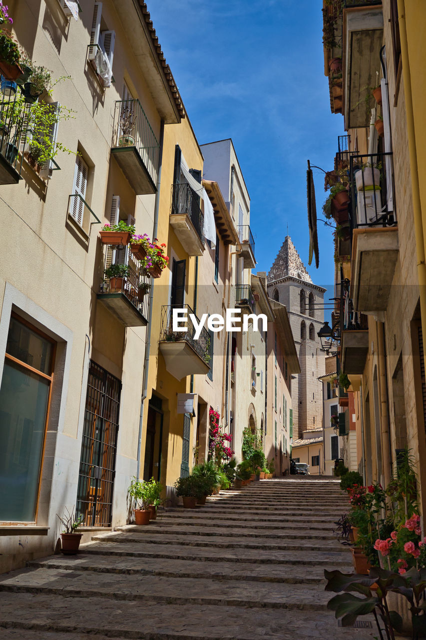 FOOTPATH AMIDST BUILDINGS IN TOWN