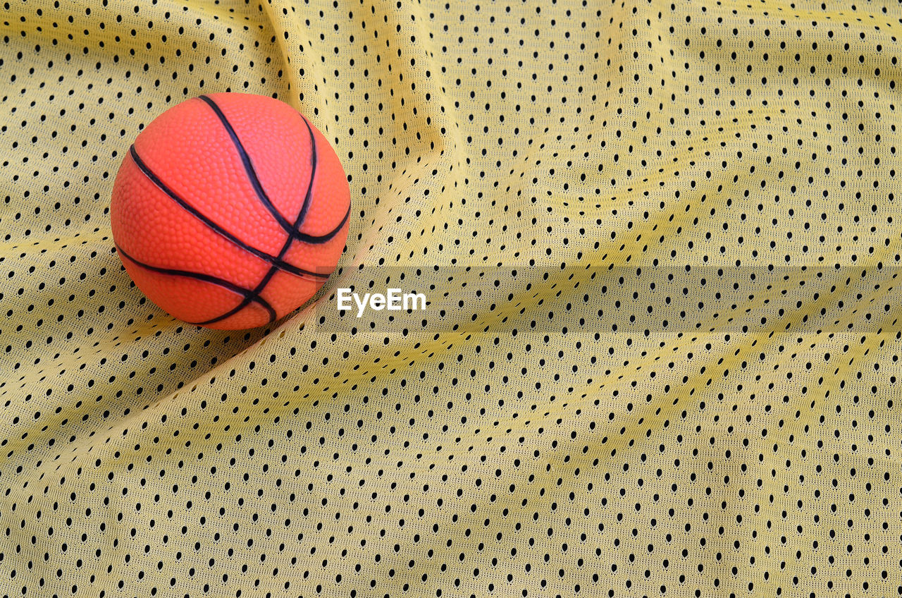 Directly above shot of basketball on patterned fabric