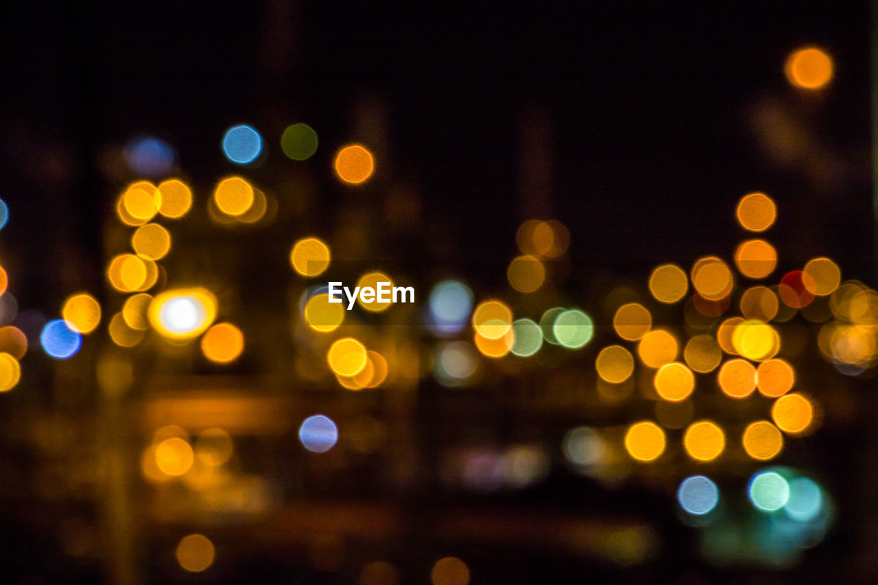 Defocused image of illuminated city at night