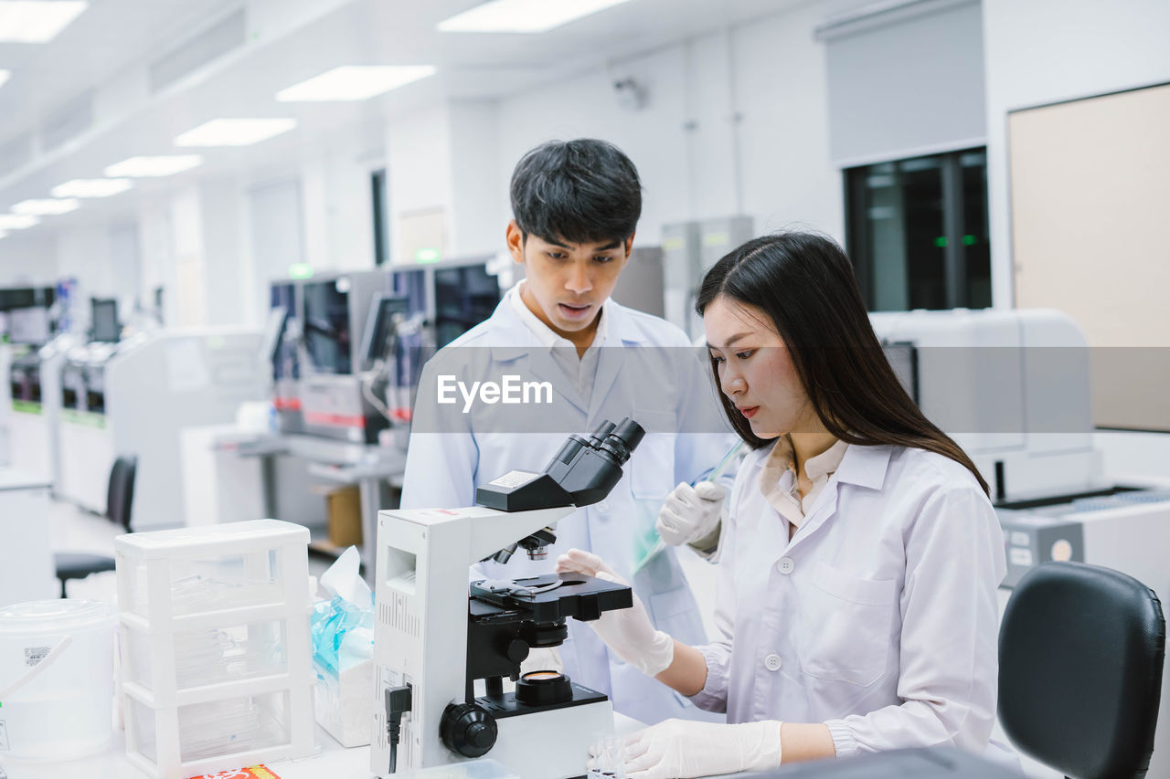 Scientist examining specimen in laboratory