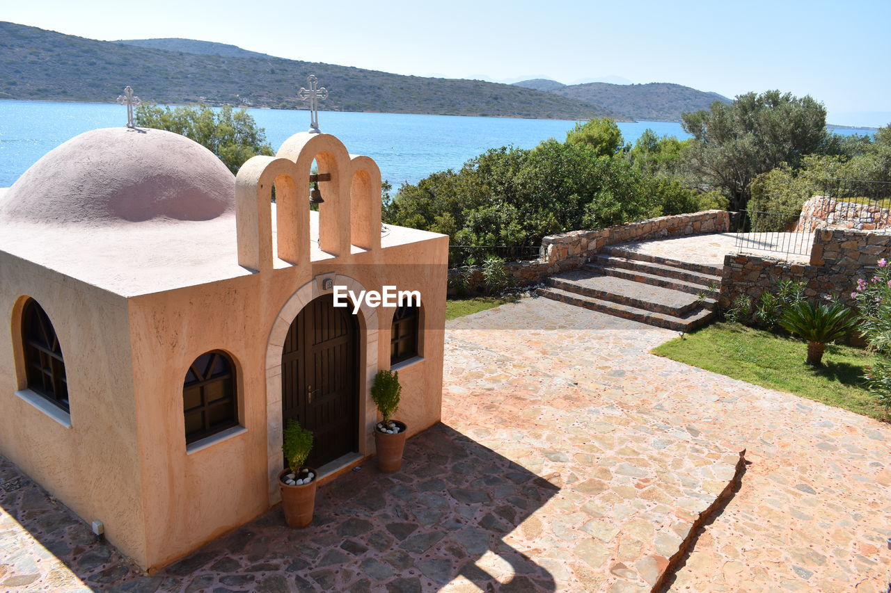 High angle view of cross by sea against sky