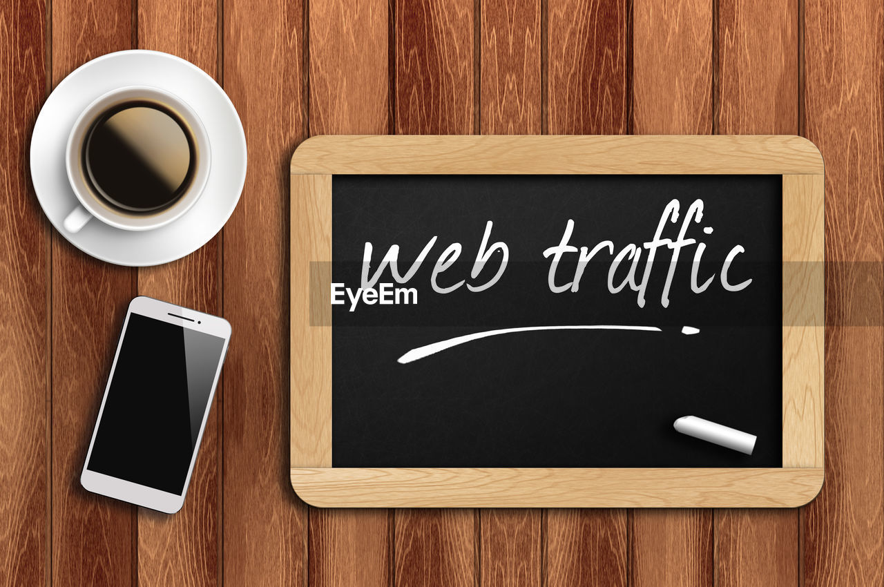 communication, wood, wireless technology, coffee, blackboard, coffee cup, cup, technology, board, mug, smartphone, food and drink, text, portable information device, font, mobile phone, drink, indoors, table, message, directly above, copy space, business, refreshment, writing, single word, no people, digital tablet, handwriting, brown, computer, western script