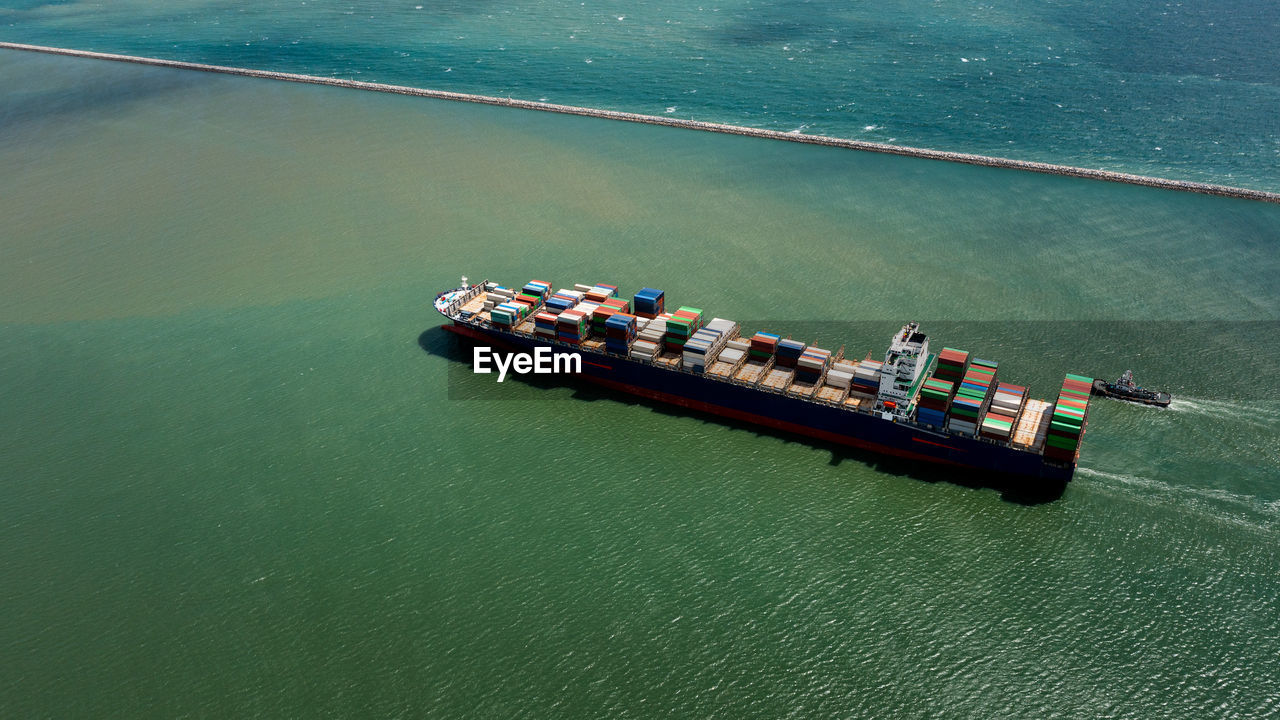 Container ship export and import business services and logistics. shipping cargo to harbor transport