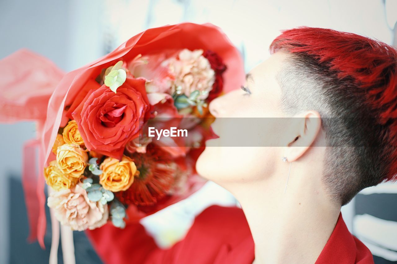 close-up of young woman with roses