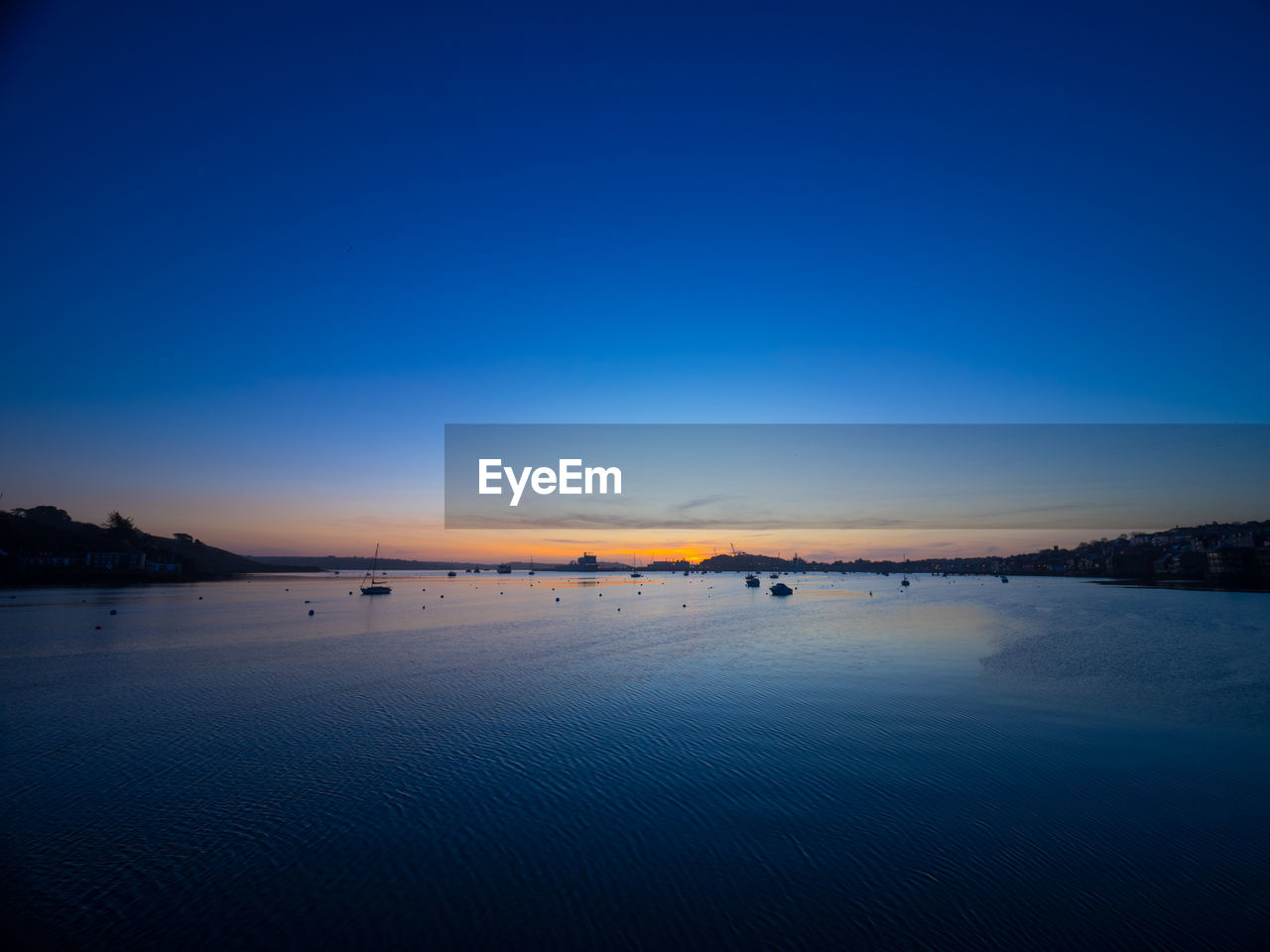 Scenic view of sea against clear blue sky