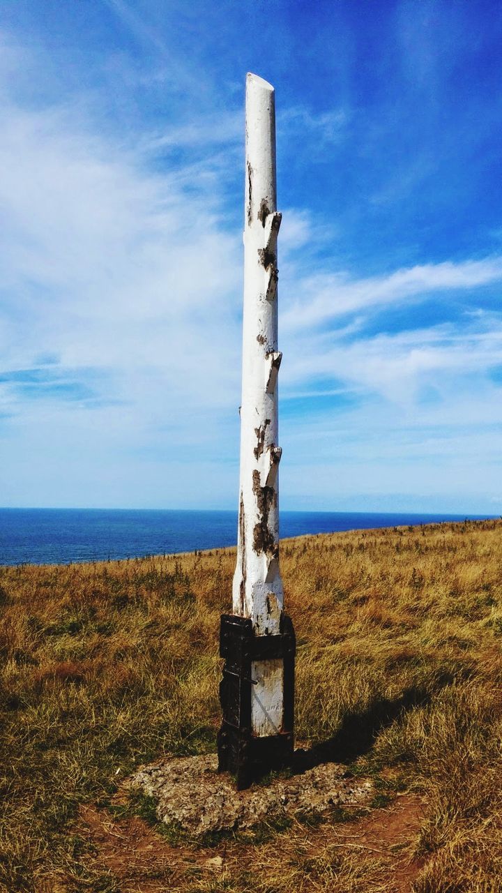 LIFEGUARD HUT ON FIELD AGAINST SKY