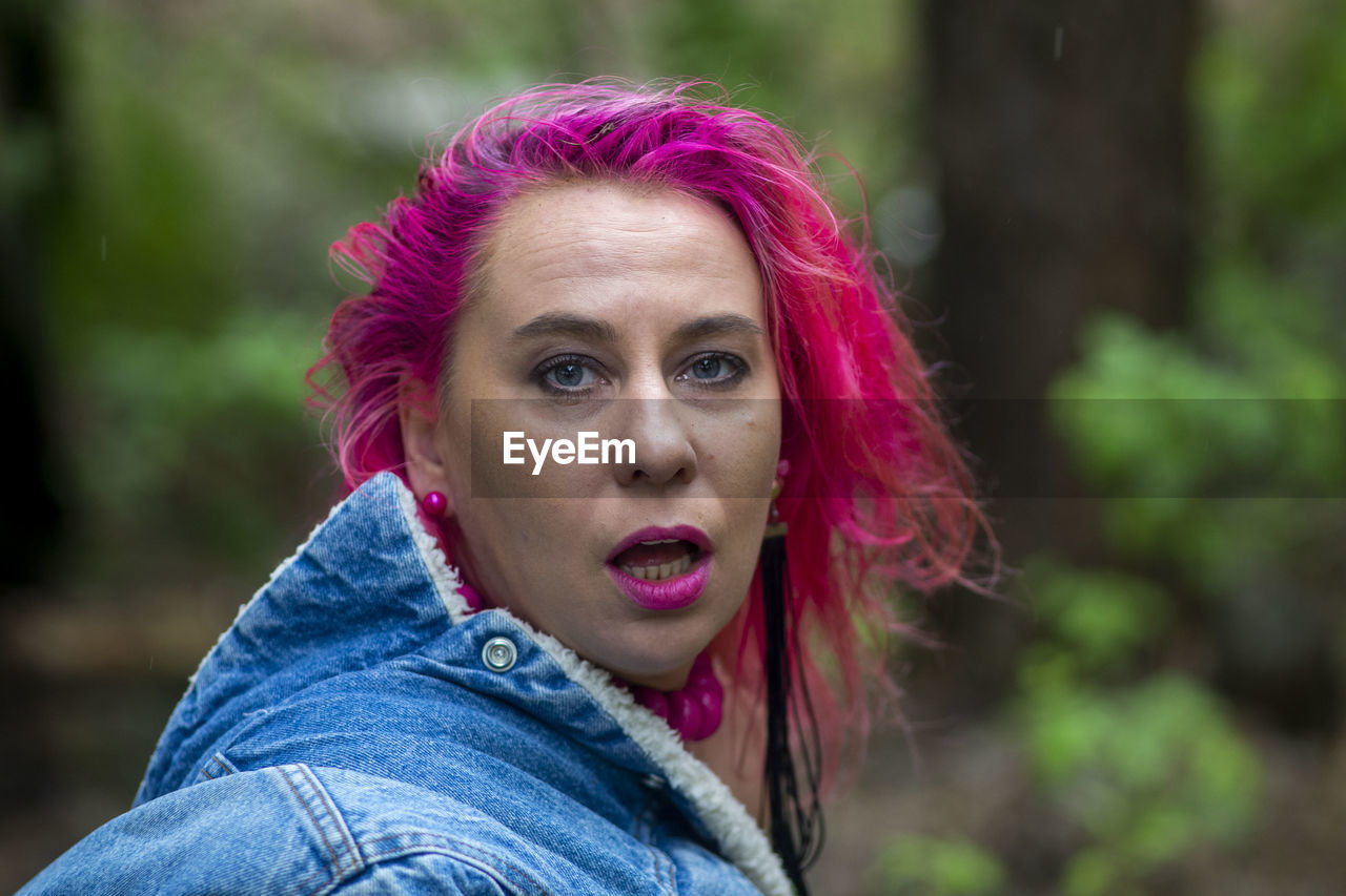 PORTRAIT OF YOUNG WOMAN WITH PINK EYES