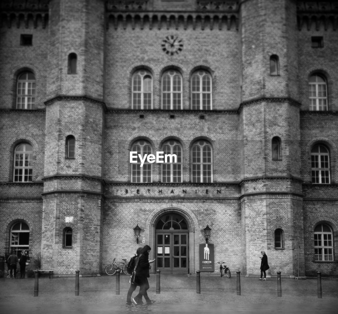 People walking outside historic building