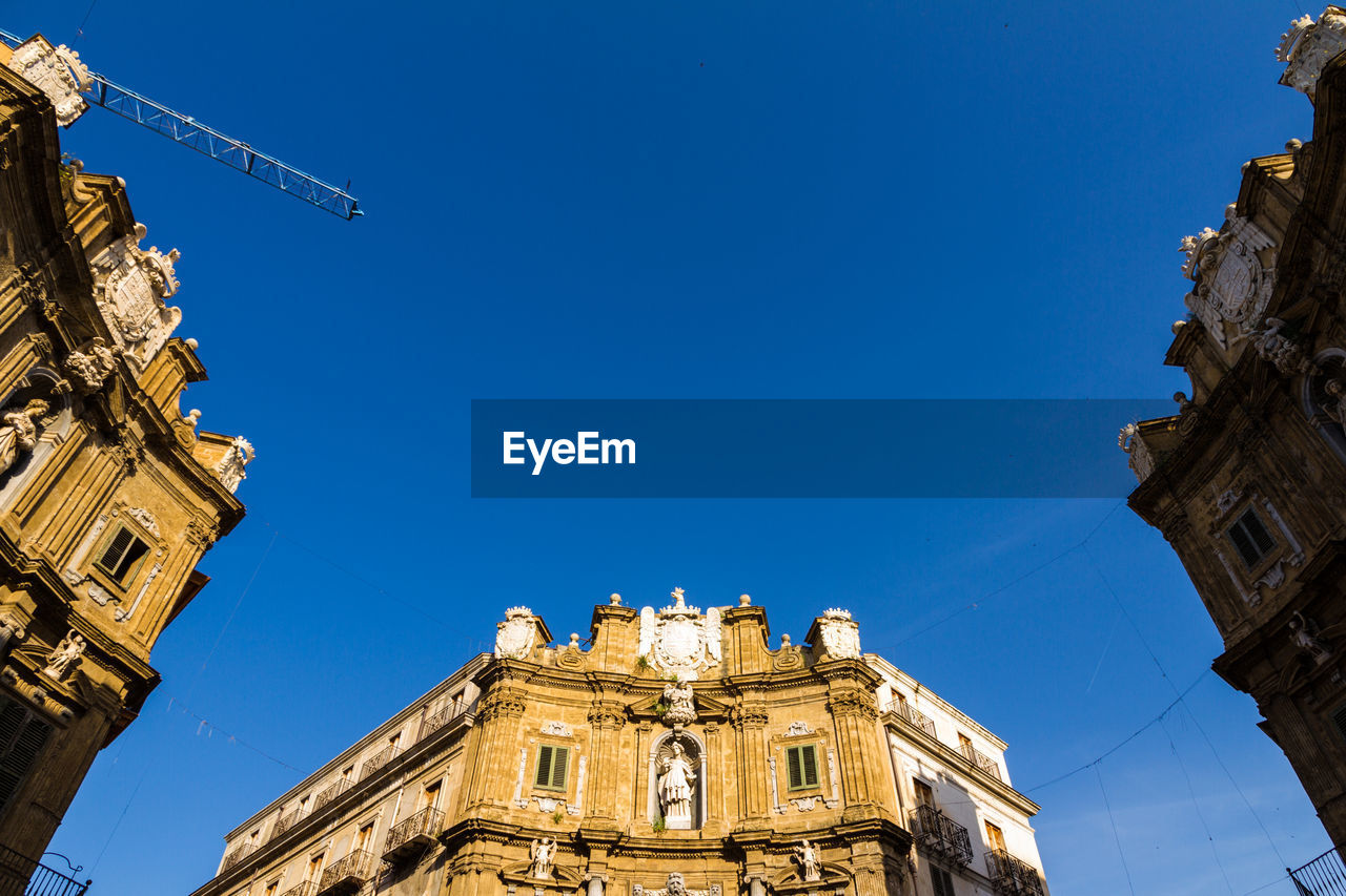 LOW ANGLE VIEW OF A BUILDING AGAINST BLUE SKY