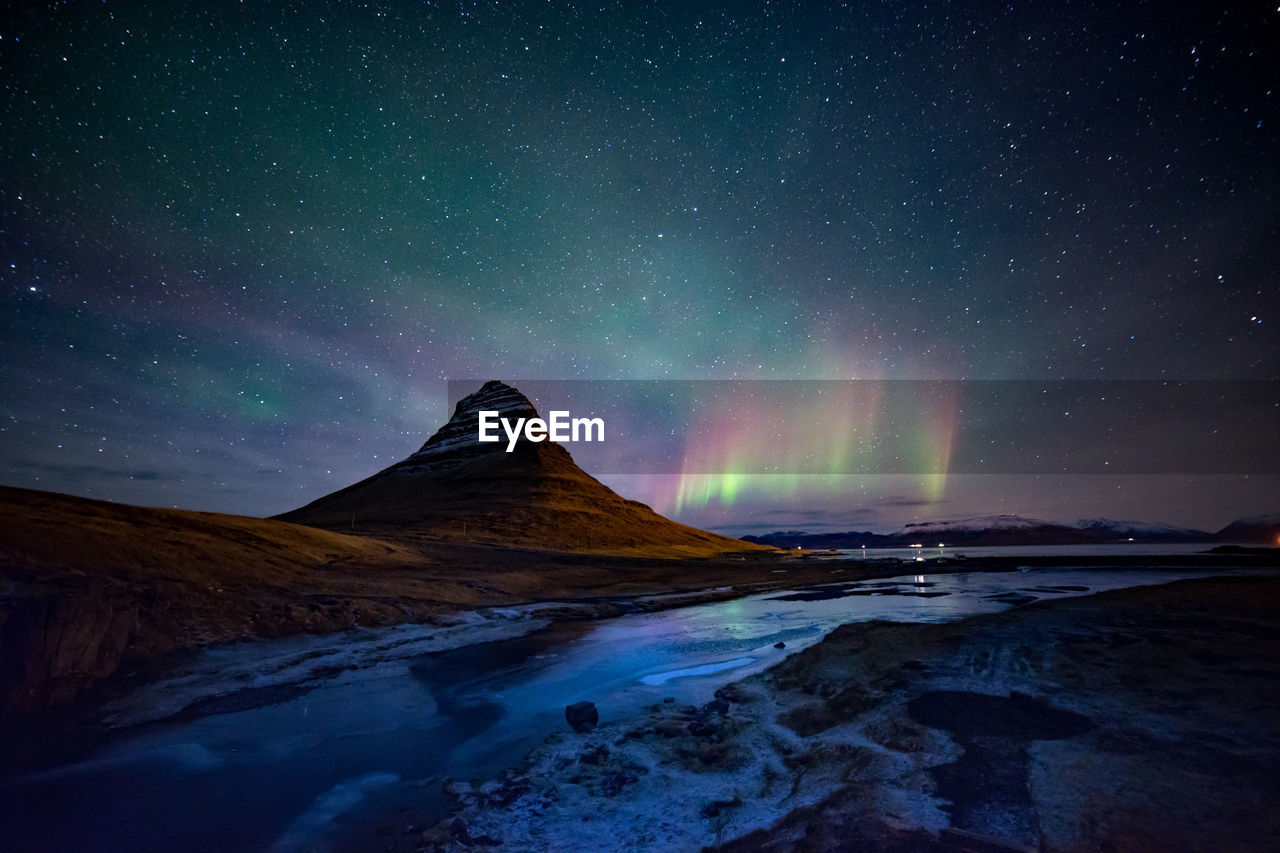 Scenic view of mountains against sky at night