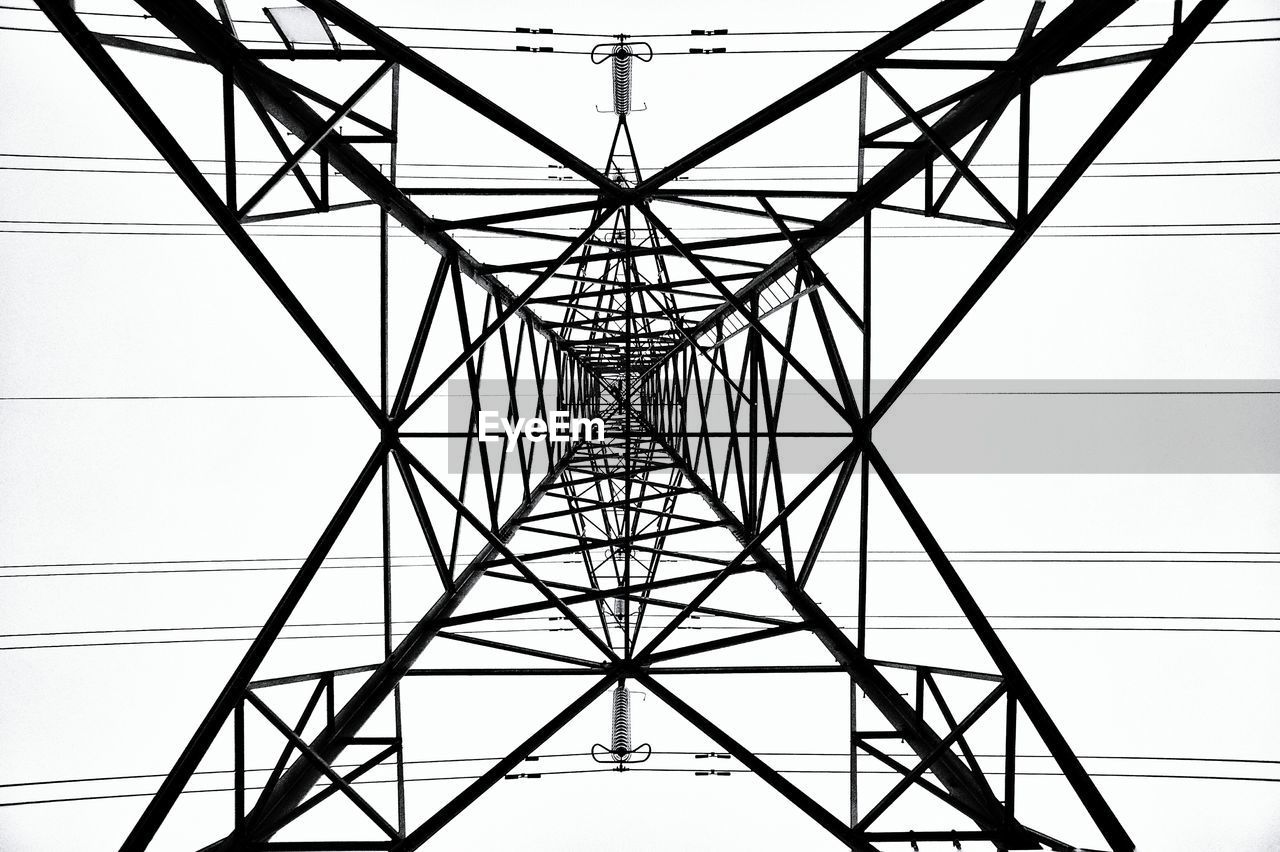 Low angle view of electricity pylon against clear sky