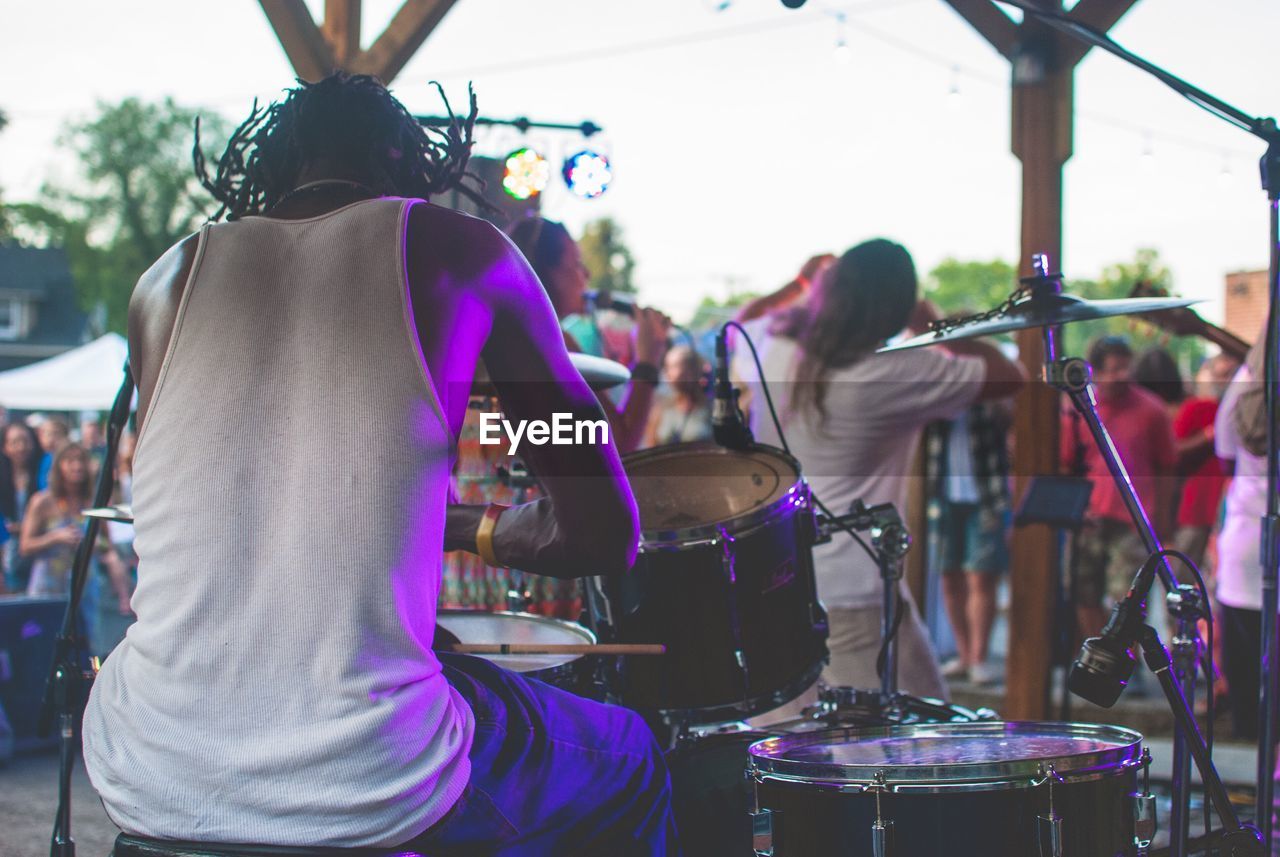 REAR VIEW OF PEOPLE WATCHING MUSIC CONCERT