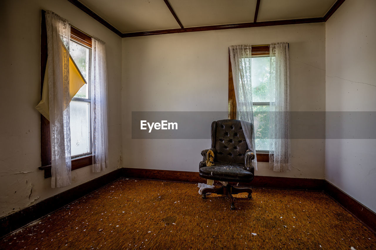 Empty chair in abandoned home