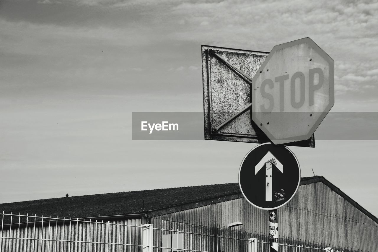 Low angle view of street signs against sky