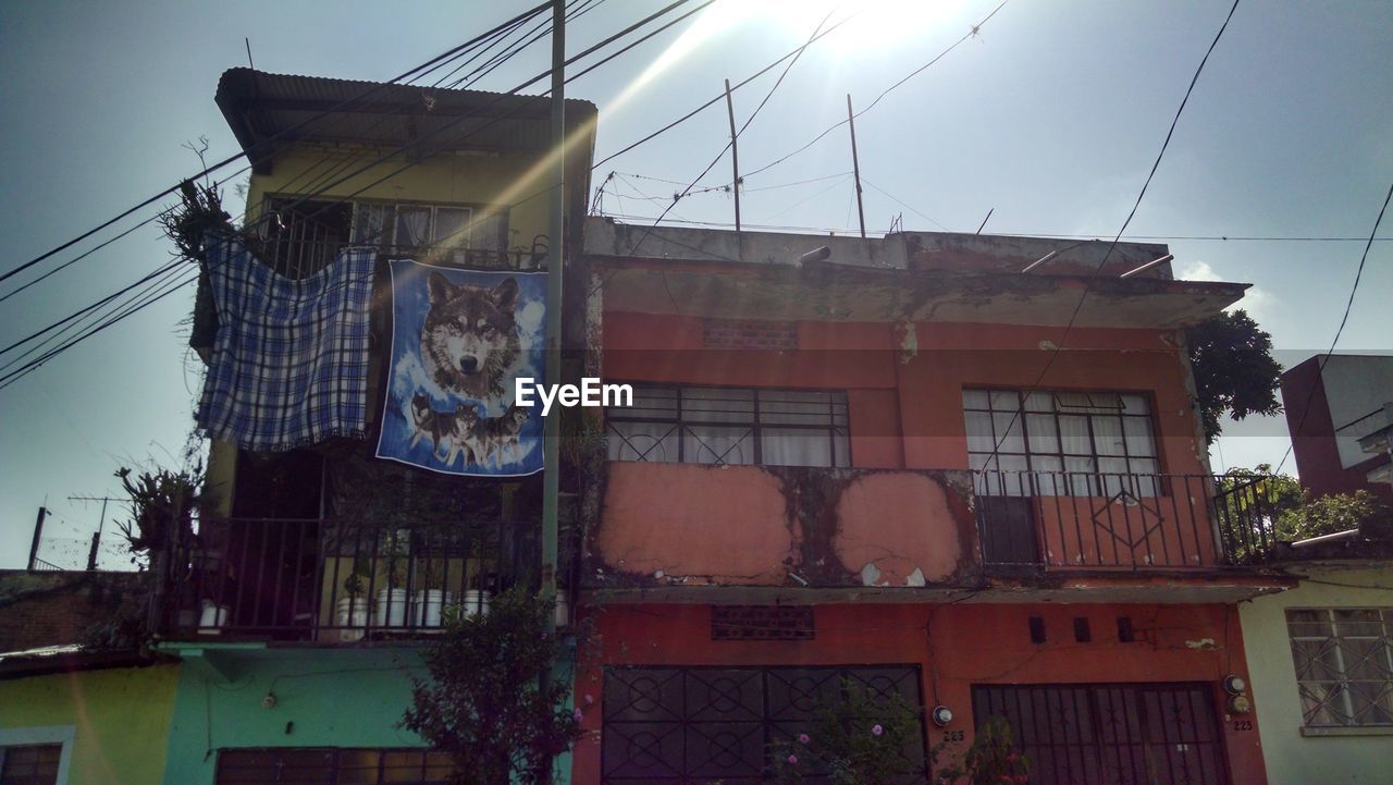 LOW ANGLE VIEW OF CLOTHES DRYING ON BUILDING