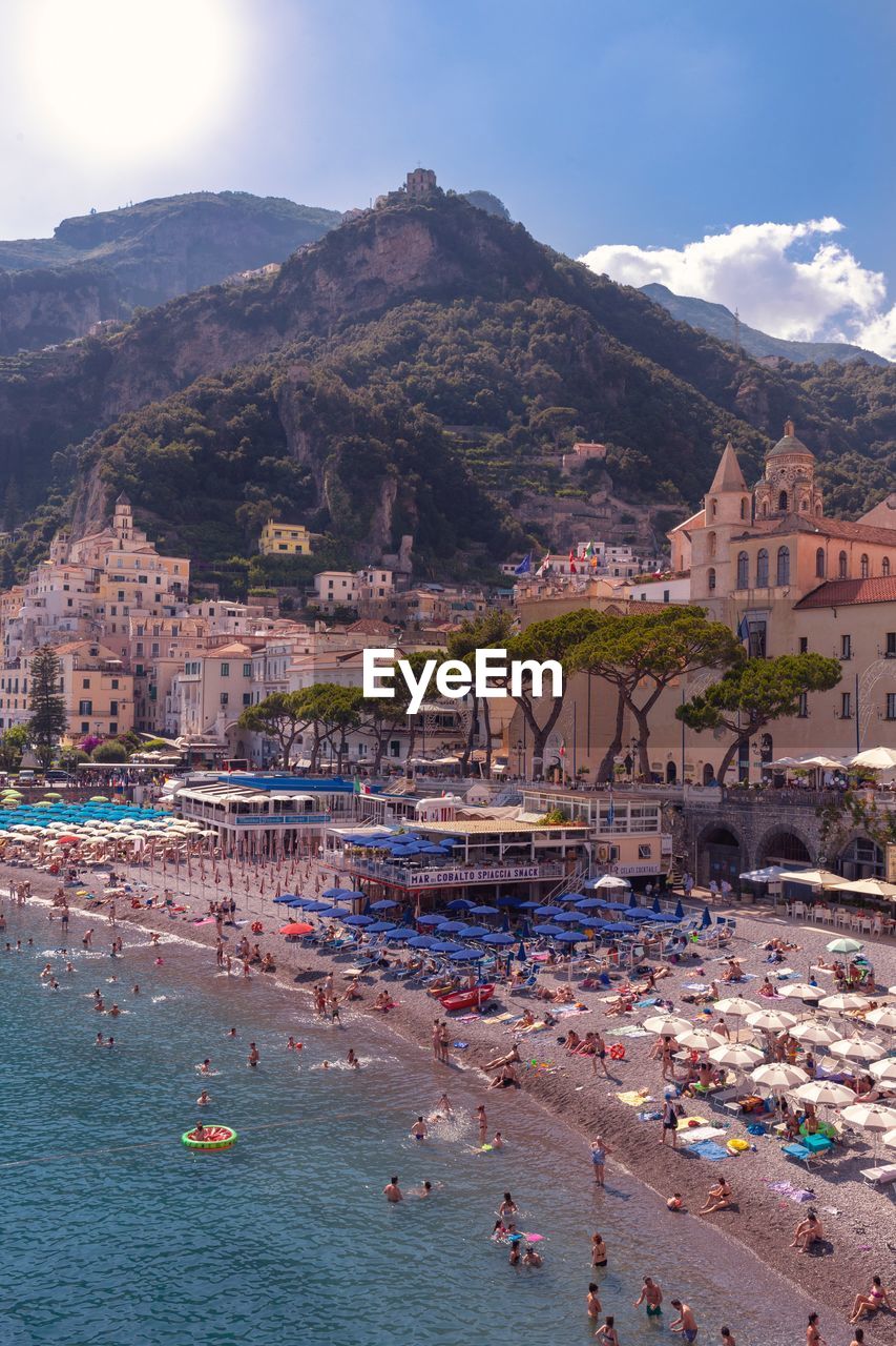 High angle view of buildings by sea against sky