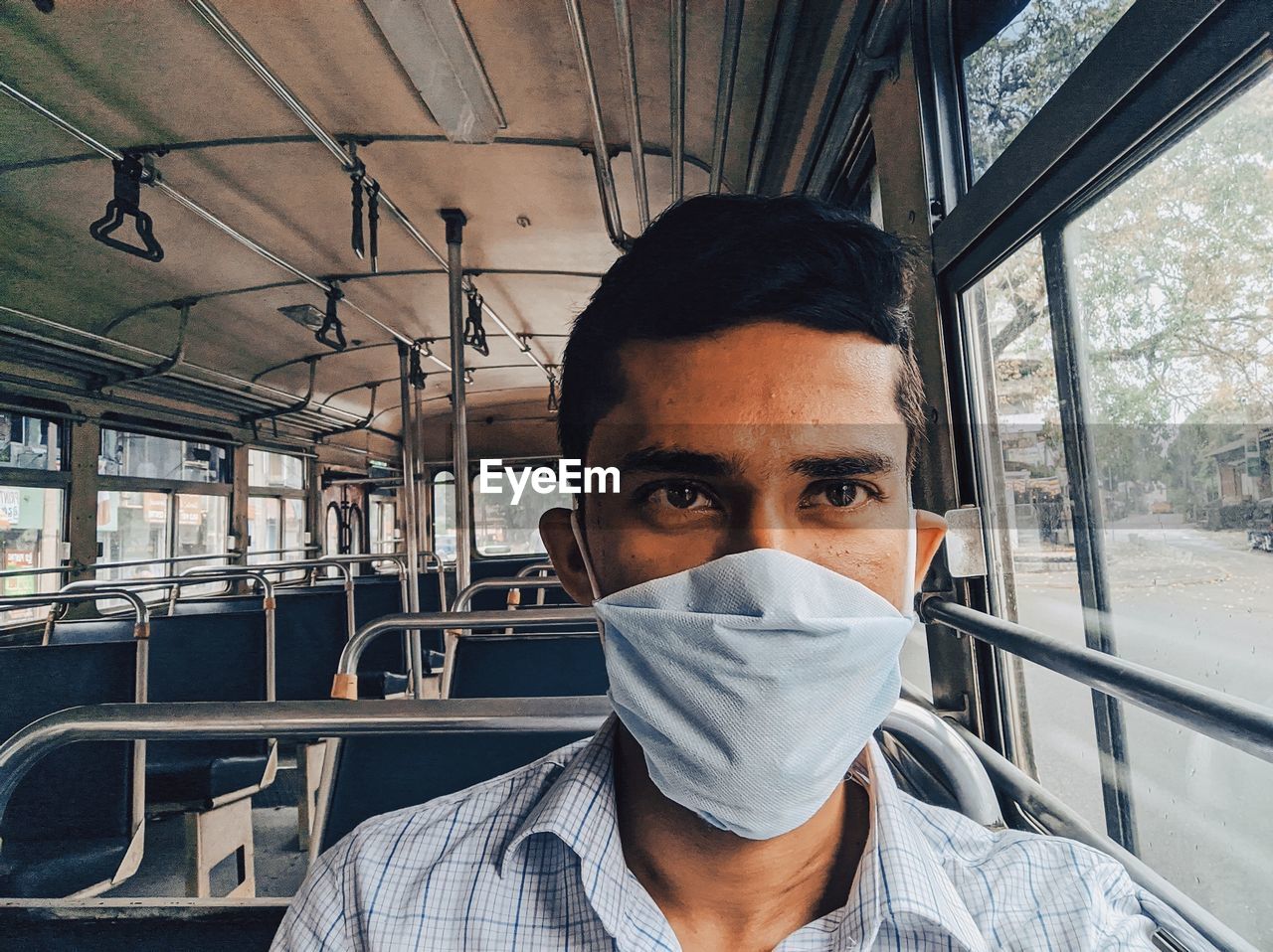 Portrait of young man in train