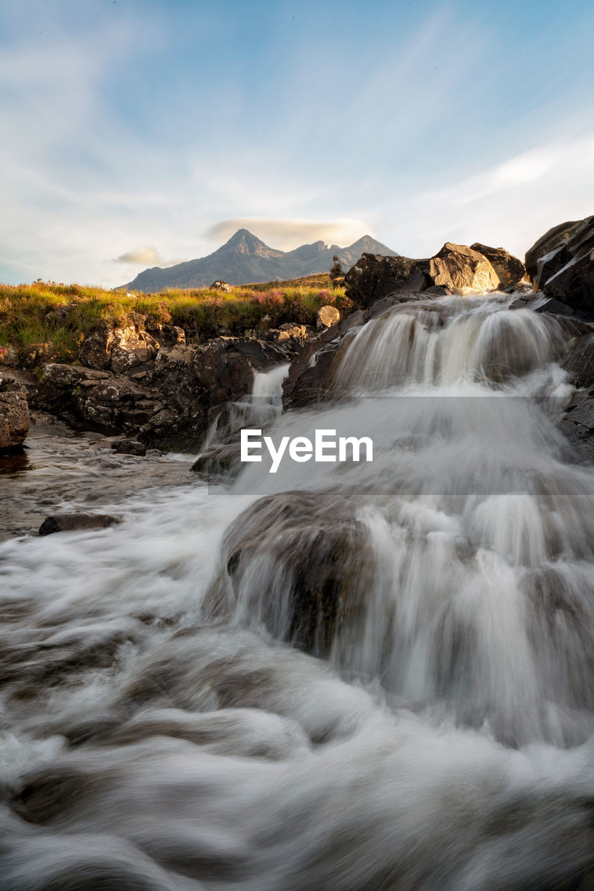 Scenic view of waterfall against sky