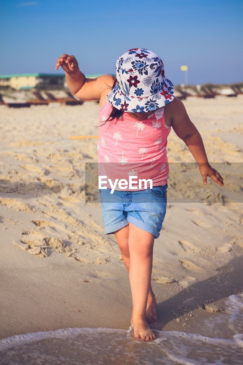 Full length of girl walking at beach