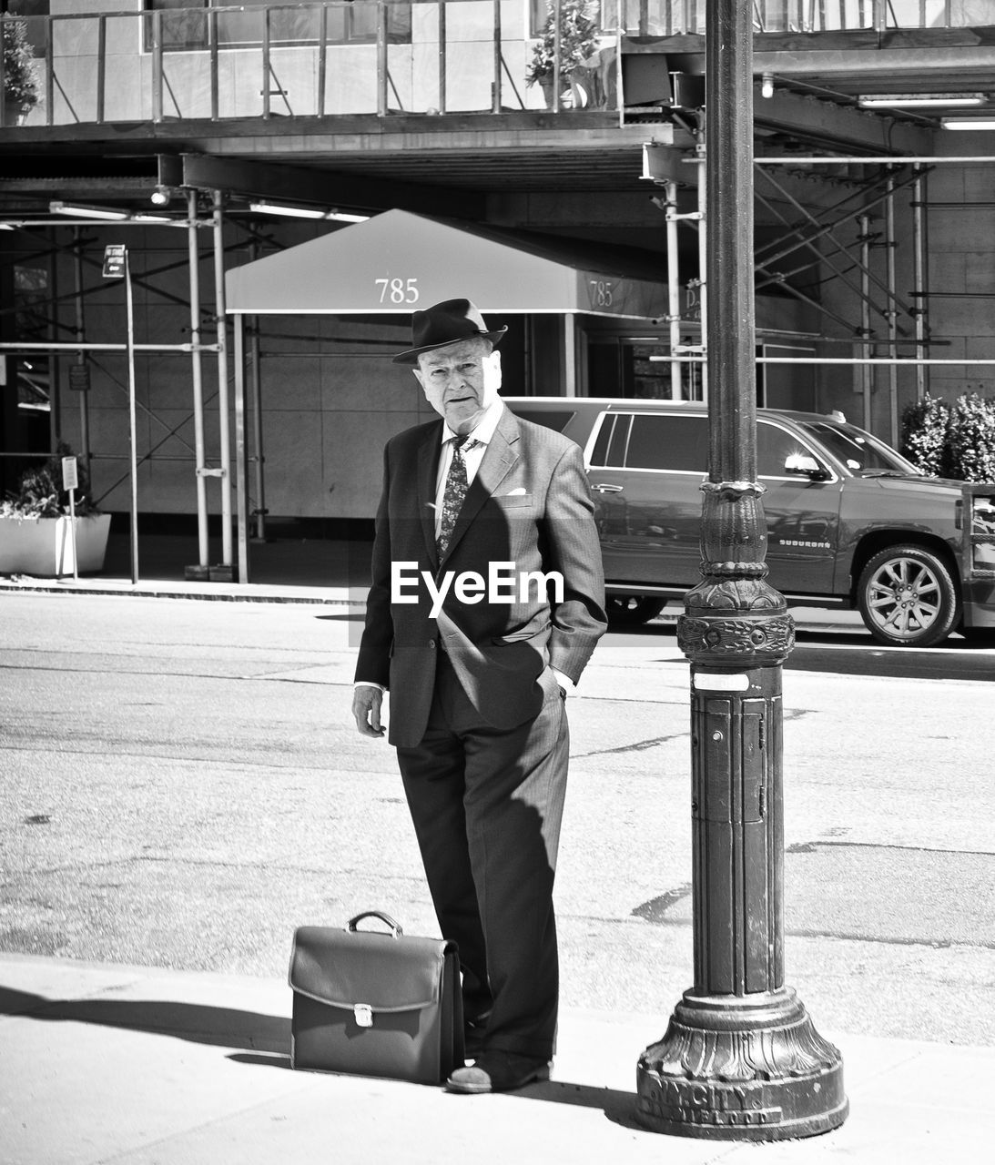 FULL LENGTH PORTRAIT OF YOUNG MAN STANDING ON CAR