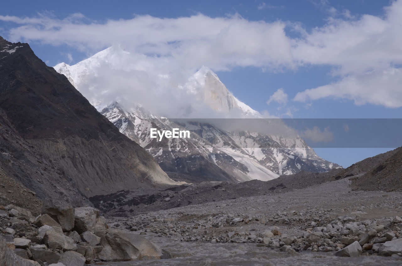 Scenic view of mountains against cloudy sky