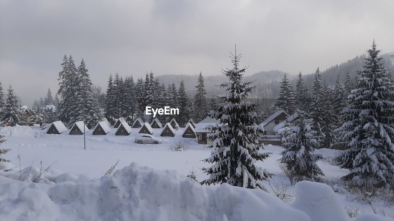 Snow covered landscape against sky