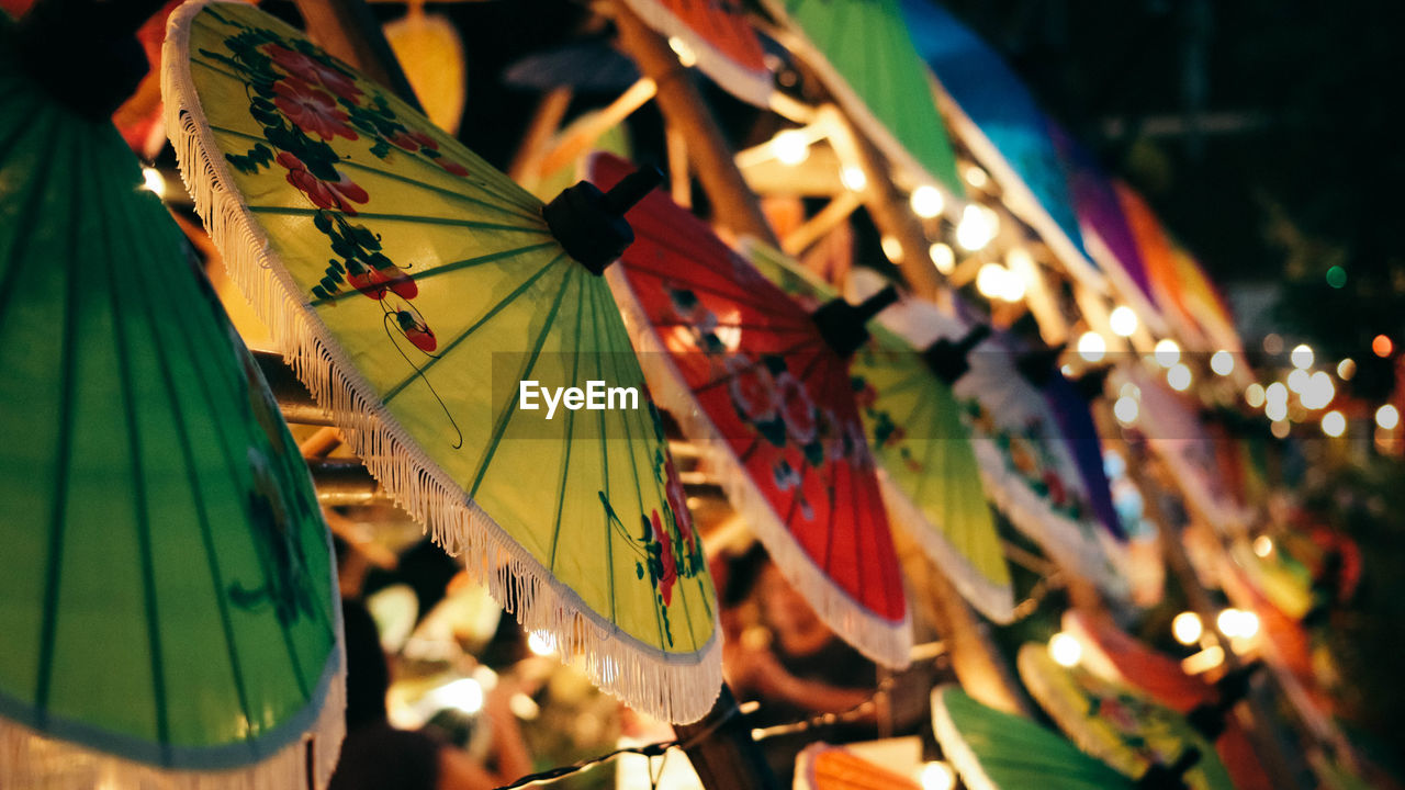 Close-up of multi colored decorations hanging in row