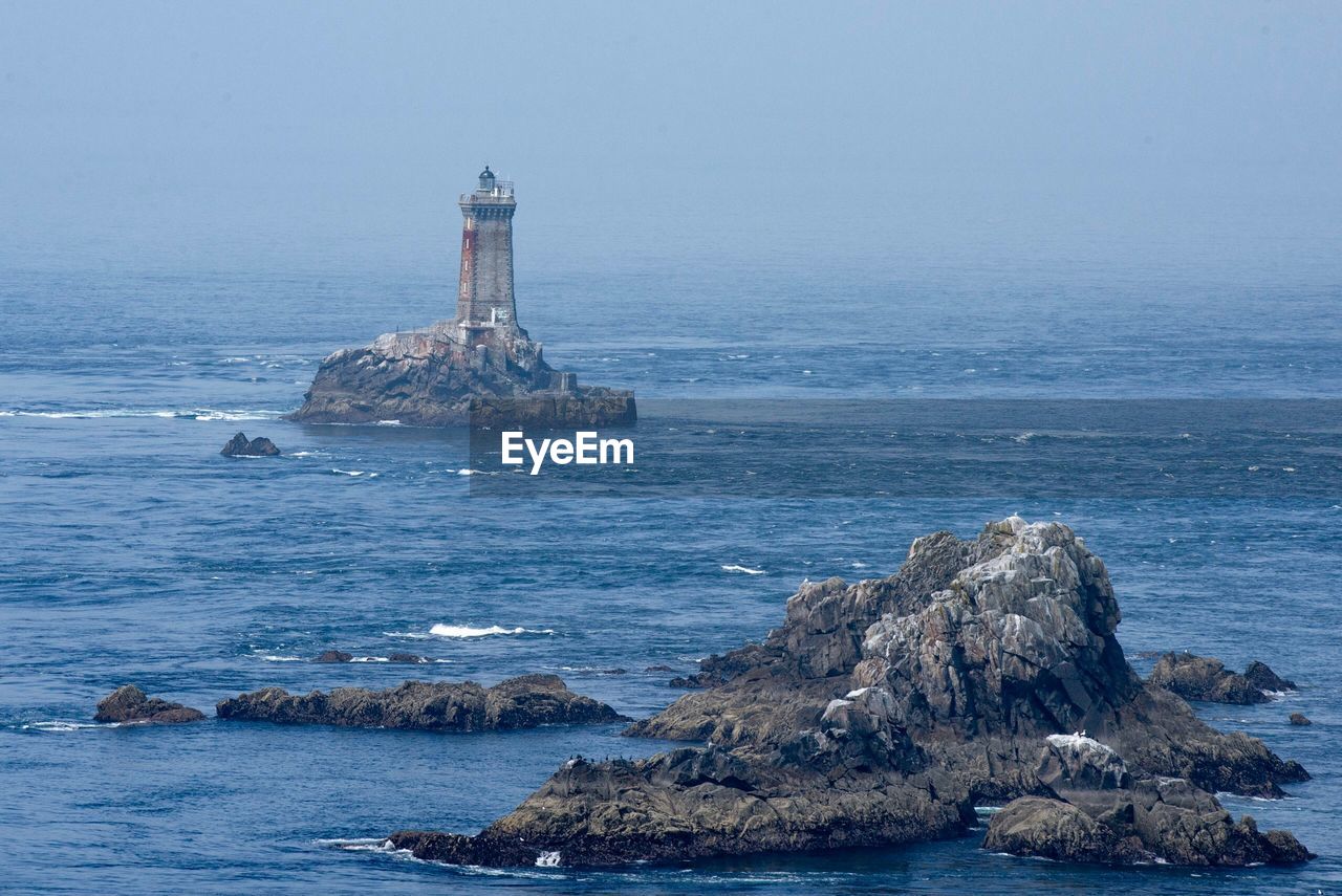 LIGHTHOUSE BY SEA AGAINST SKY