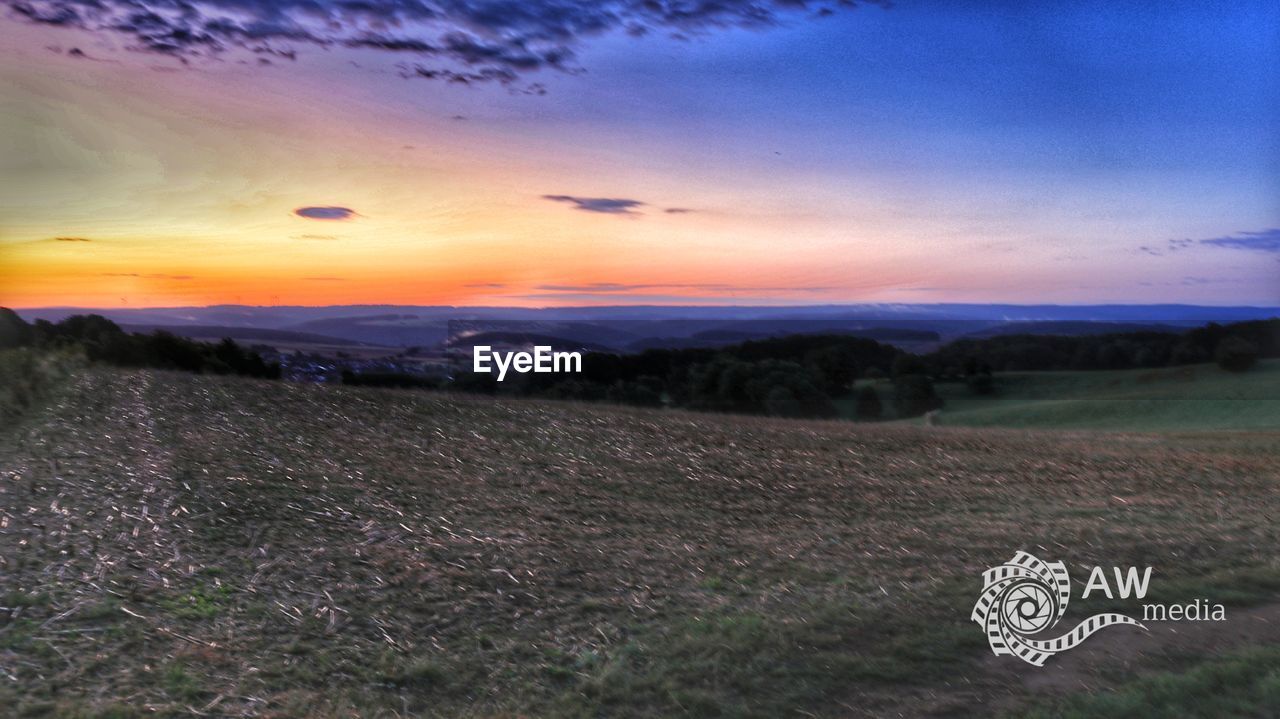 SCENIC VIEW OF LAND DURING SUNSET