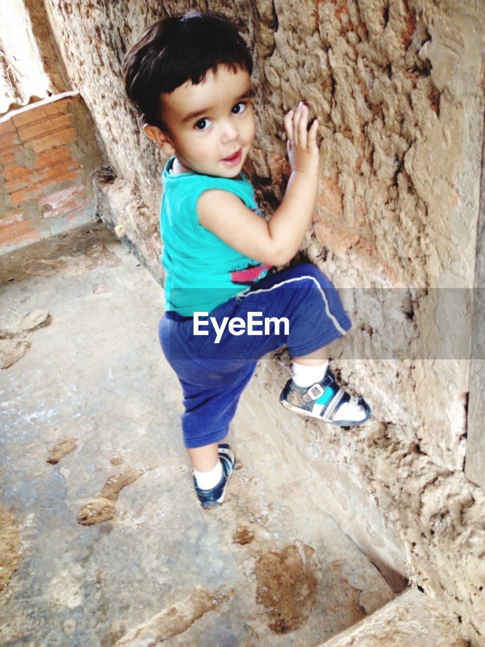 HIGH ANGLE PORTRAIT OF CUTE BOY OUTDOORS