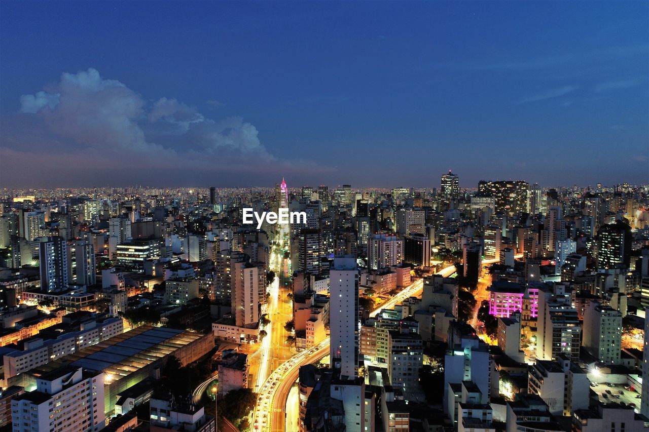 High angle view of illuminated city buildings against sky