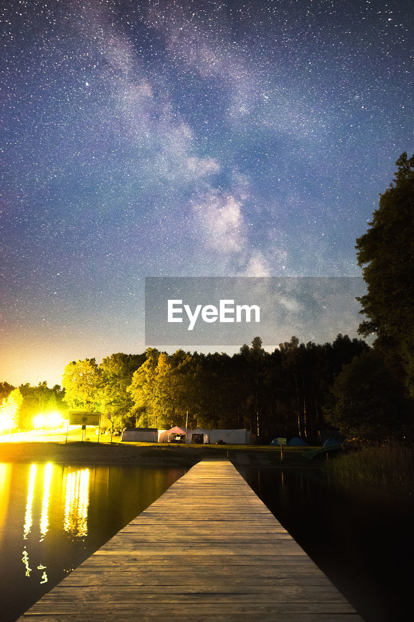 Scenic view of lake against sky at night