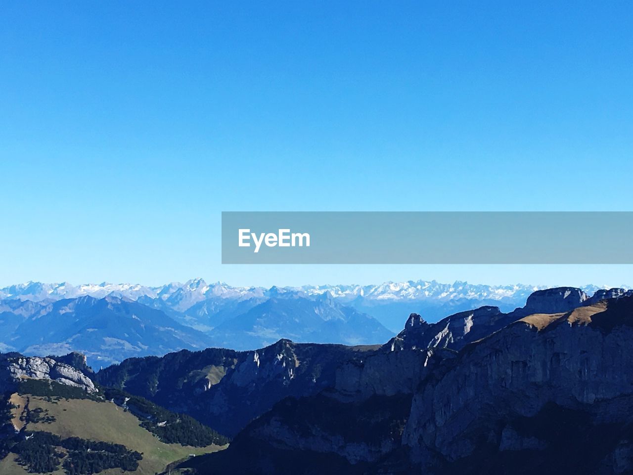 MOUNTAINS AGAINST CLEAR BLUE SKY