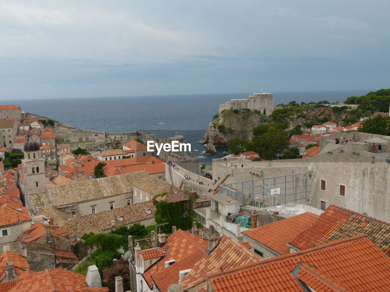 High angle view of buildings by sea against sky in old town