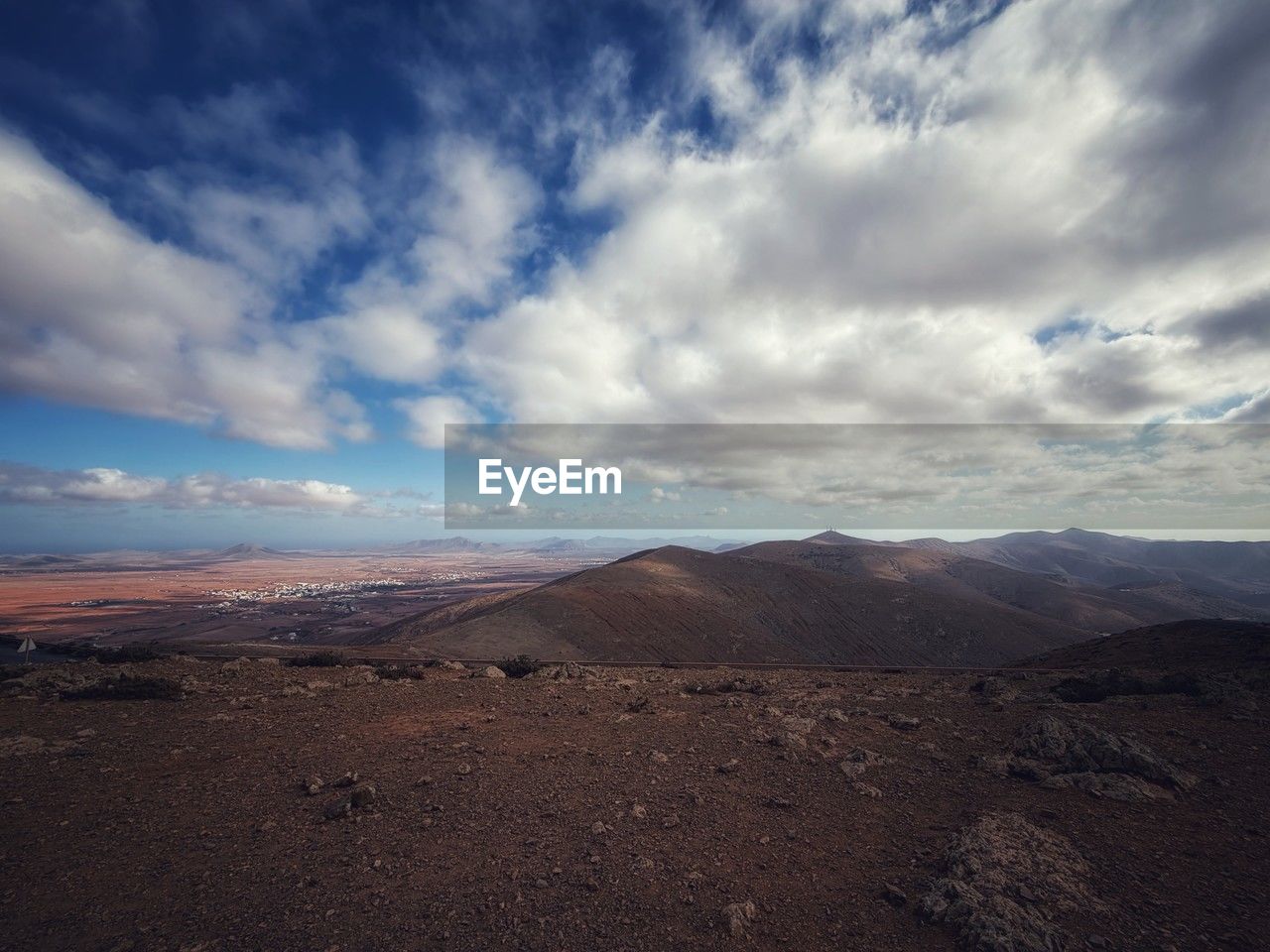 landscape, environment, cloud, sky, scenics - nature, horizon, mountain, land, beauty in nature, nature, desert, natural environment, travel destinations, no people, travel, climate, non-urban scene, dramatic sky, mountain range, arid climate, tranquility, outdoors, cloudscape, plain, tourism, extreme terrain, tranquil scene, plateau, semi-arid, remote, blue, horizon over land, awe, wilderness, sand, day, sea, barren, soil, dawn