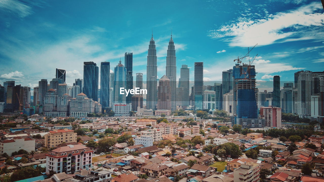 Panoramic view of buildings in city against sky