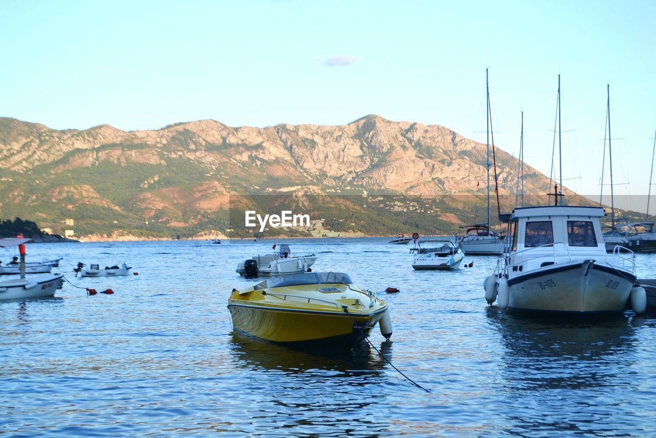 BOATS MOORED ON SEA