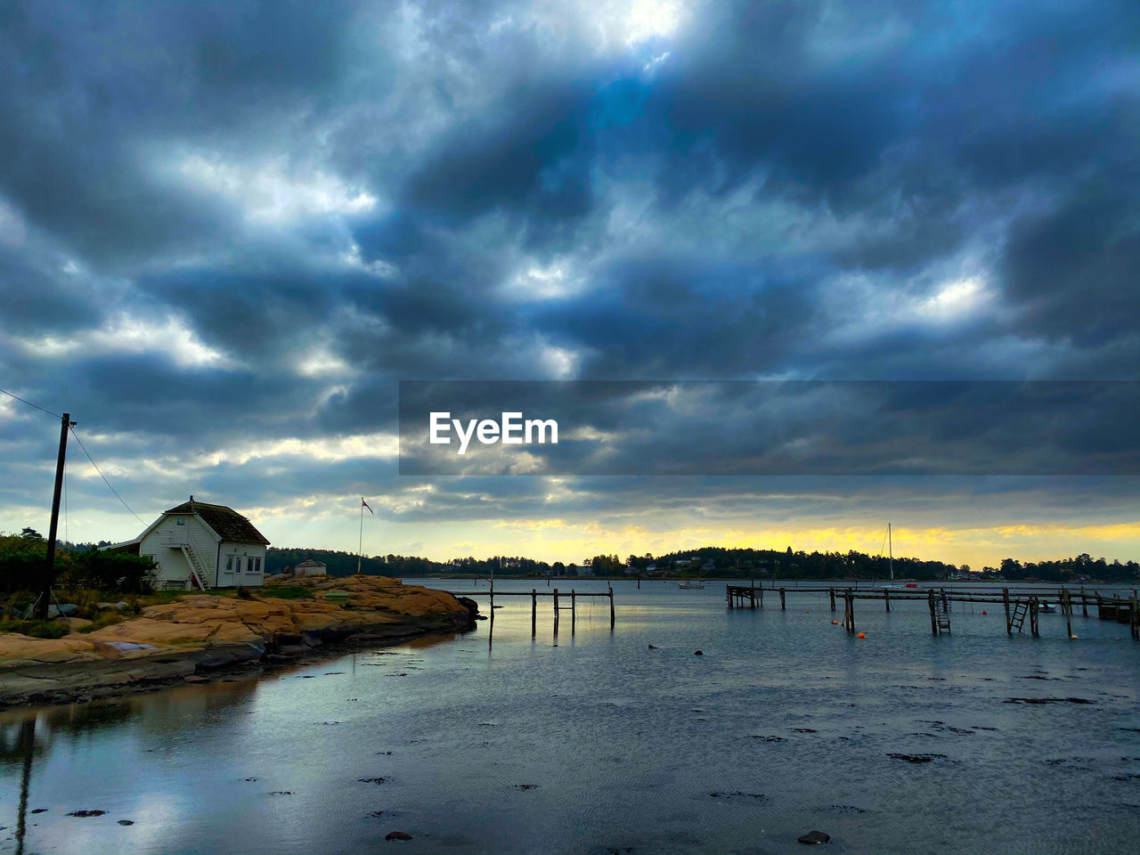 PANORAMIC VIEW OF SEA AND BUILDINGS AGAINST DRAMATIC SKY