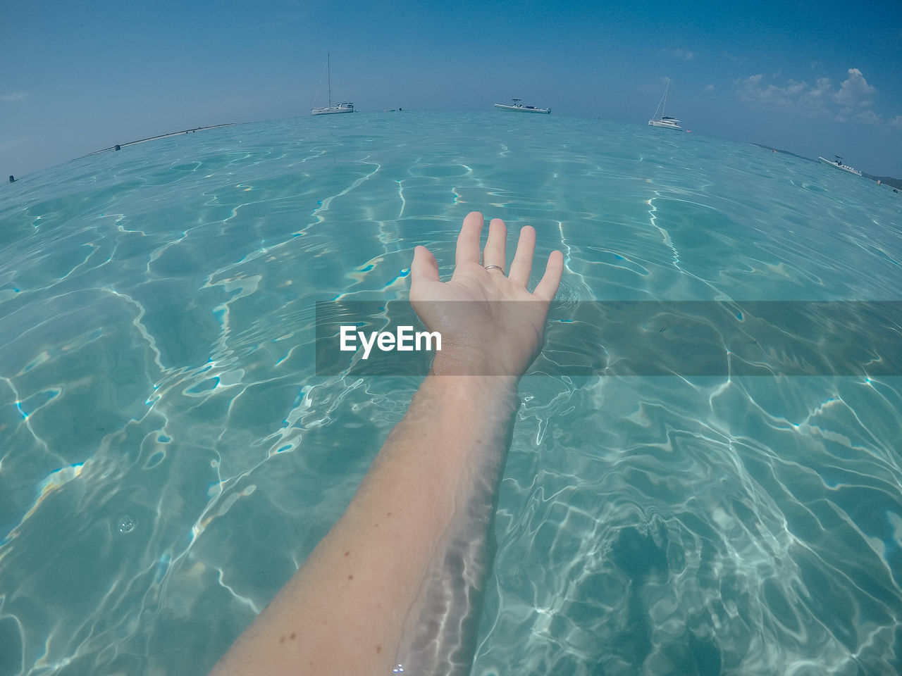 Cropped image of woman swimming in sea