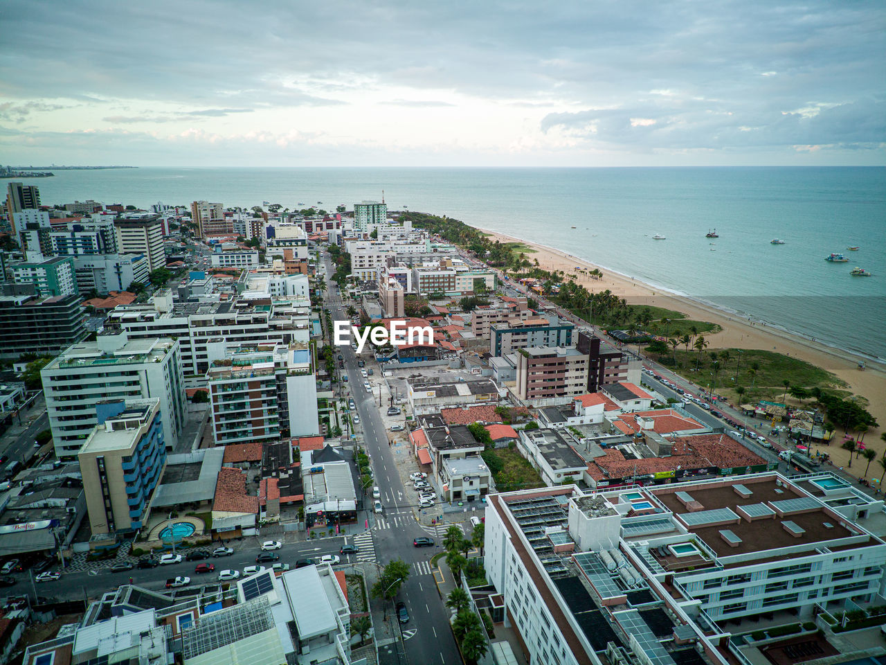 High angle view of townscape by sea against sky